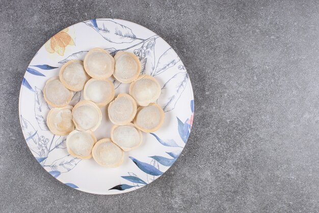 Homemade boiled dumplings on colorful plate