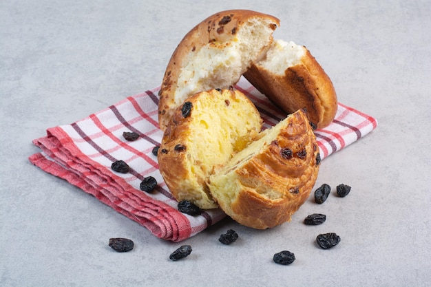 Homemade buns with raisins and cheese on tablecloth. High quality photo