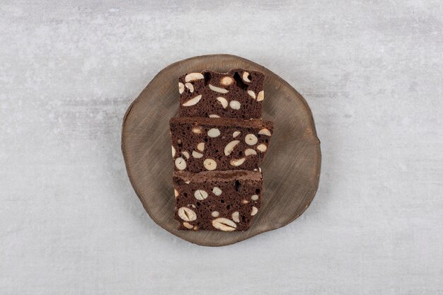 Homemade chocolate brownies on a board , on the marble table. 