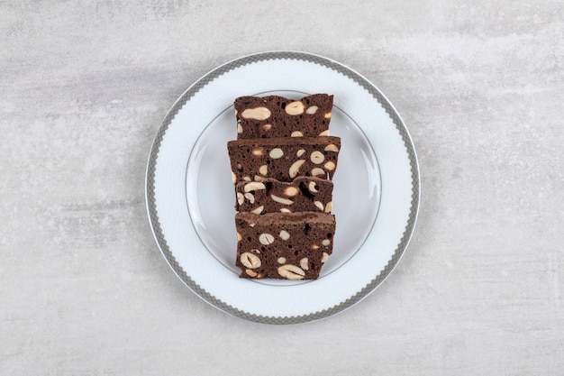 Homemade chocolate brownies on a plate , on the marble table.