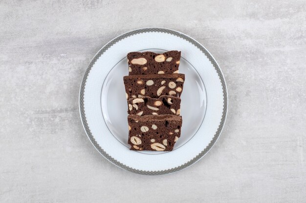 Homemade chocolate brownies on a plate , on the marble table. 