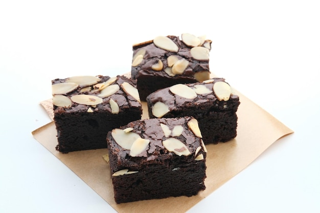 Homemade chocolate fudge brownie with almond topping close up selected focus image