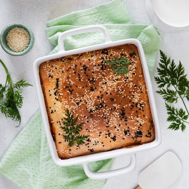 Homemade closed pie with vegetables on a white concrete background Ingredients for a cabbage and carrot pie on the table Square