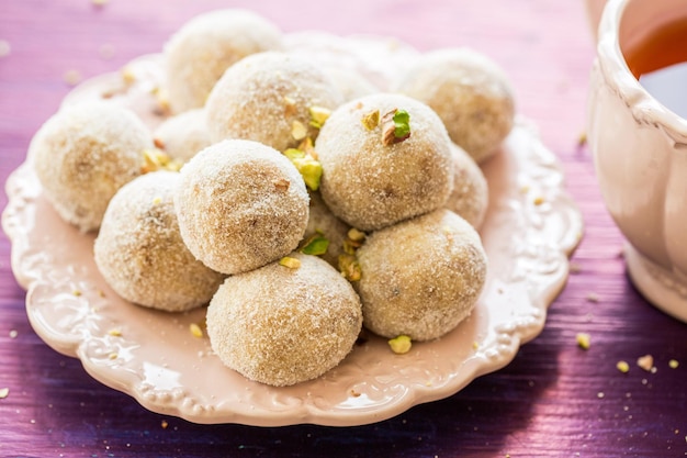 Homemade coconut balls decorated with little pink flowers