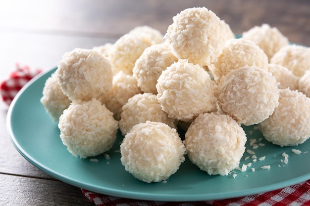 Homemade coconut balls on rustic wooden table