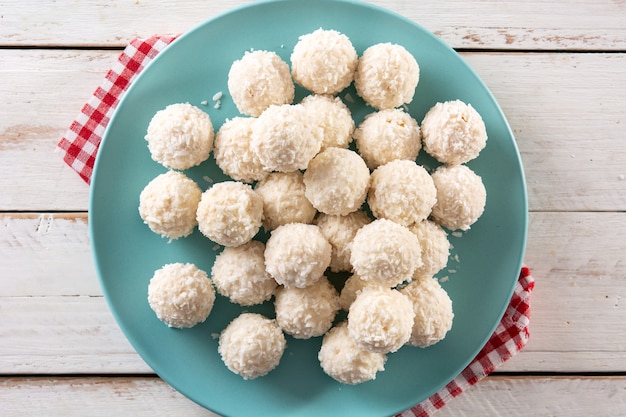 Free photo homemade coconut balls on white wooden table