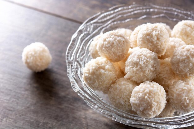 Homemade coconut balls on wooden table