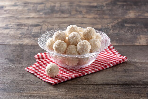 Homemade coconut balls on wooden table