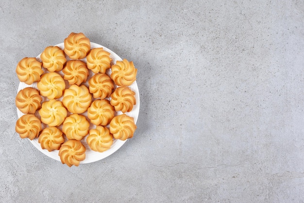 Homemade cookies on a plate on marble background. 