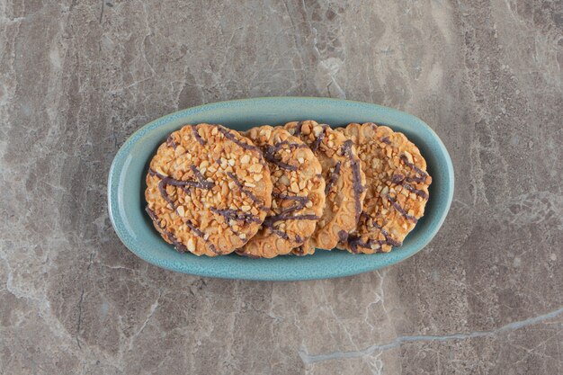 Homemade cookies on a plate on marble.