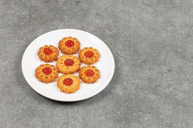 Homemade cookies with jelly on white plate