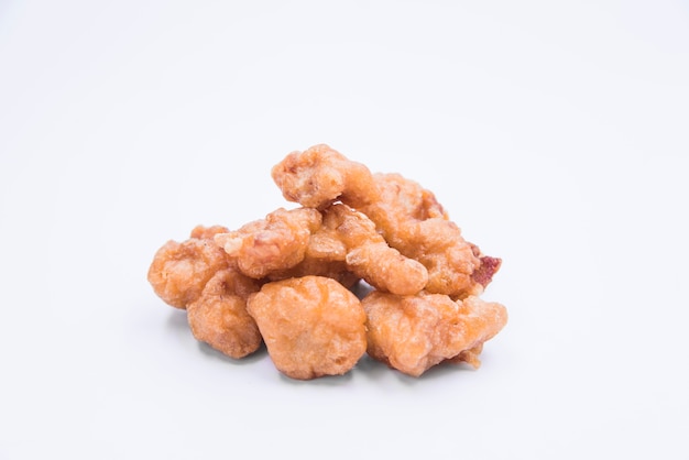 Homemade crispy chicken popcorn over white background