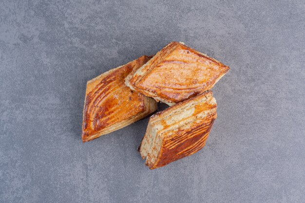 Homemade crispy pastries on marble table.