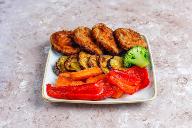 Homemade delicious cutlets with roasted vegetables.