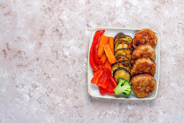Homemade delicious cutlets with roasted vegetables.