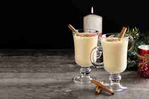 Free photo homemade eggnog with cinnamon on wooden table typical christmas dessert