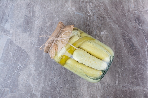 Homemade fermented cucumbers in glass jar.