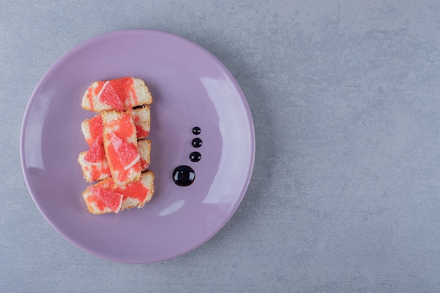 Homemade grapefruit cake on purple plate