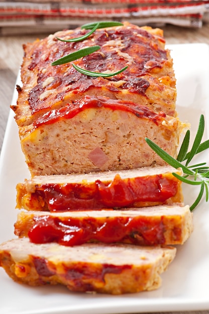 Homemade ground meatloaf with ketchup and rosemary