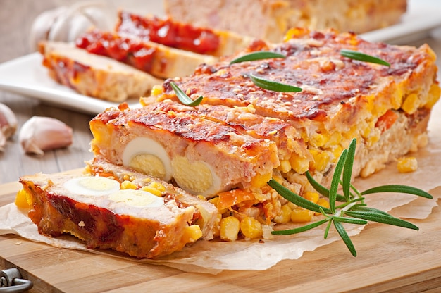 Homemade ground meatloaf with ketchup and rosemary