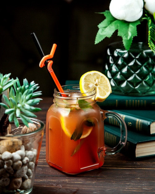 Homemade ice tea with herbs and lemon on top