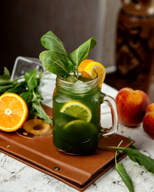 Homemade ice tea with herbs and orange