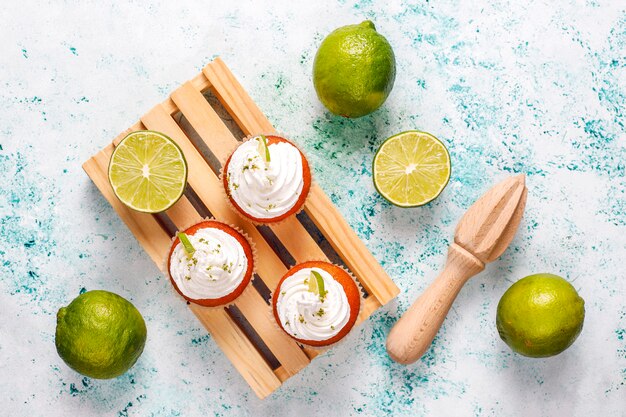 Homemade Key lime cupcakes with whipped cream and lime zest, selective focus