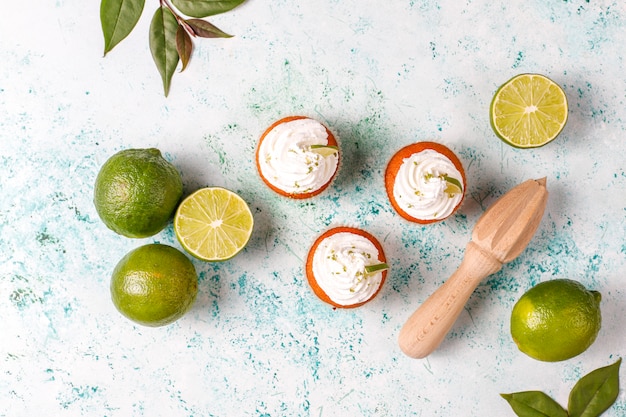 Homemade Key lime cupcakes with whipped cream and lime zest