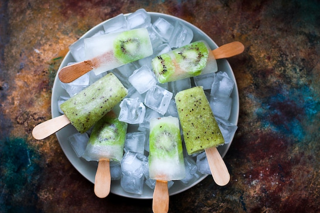 Homemade kiwi popsicles with ice cubes