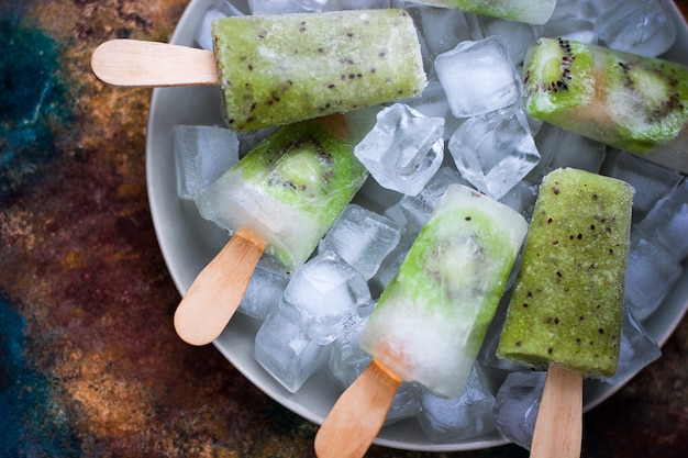 Homemade kiwi popsicles with ice cubes