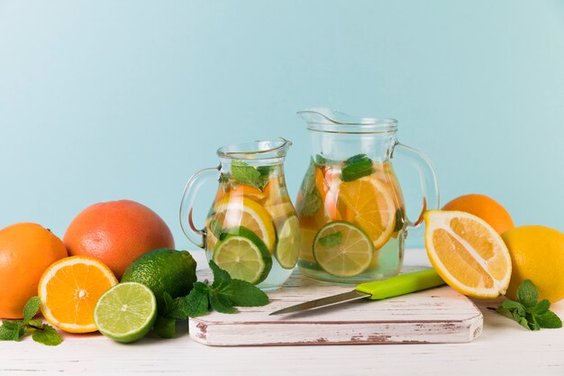 Homemade lemonade jugs with light blue background