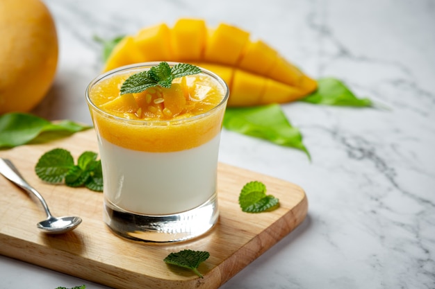 Homemade mango yoghurt on marble surface