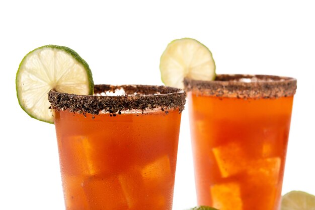 Homemade michelada cocktail with beer lime juicehot saucesalted Rim and tomato juice isolated