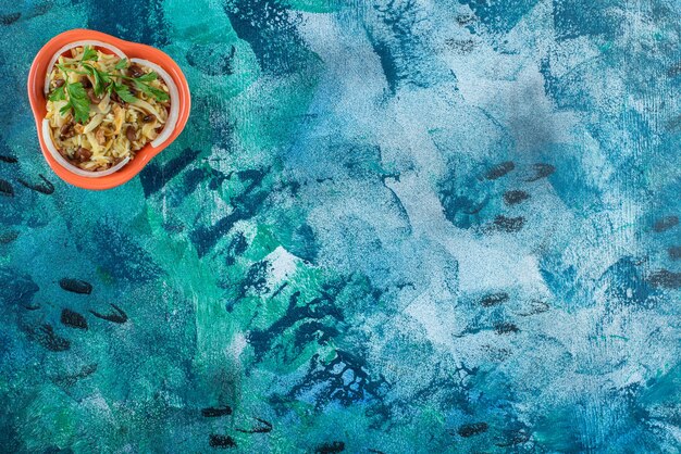 homemade noodle with beans on a bowl , on the blue table. 