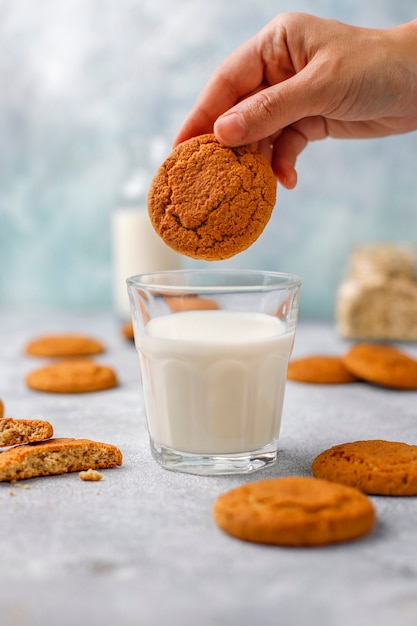 Homemade oatmeal cookies with a cup of milk.