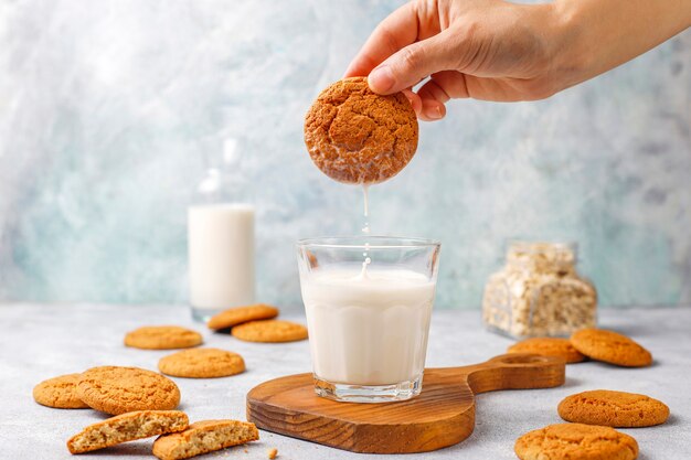 Homemade oatmeal cookies with a cup of milk.