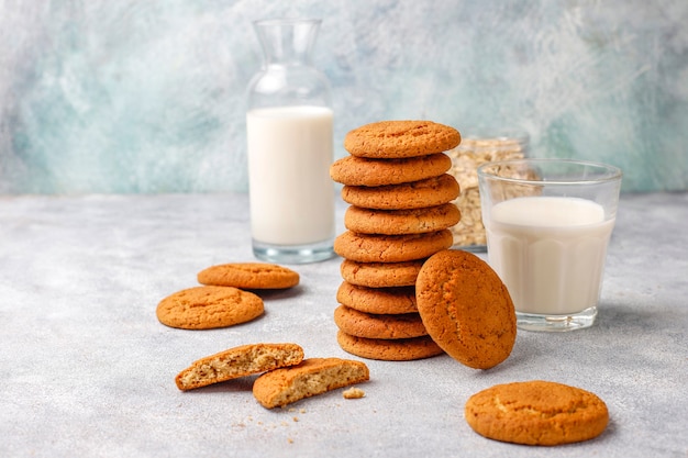 Homemade oatmeal cookies with a cup of milk.