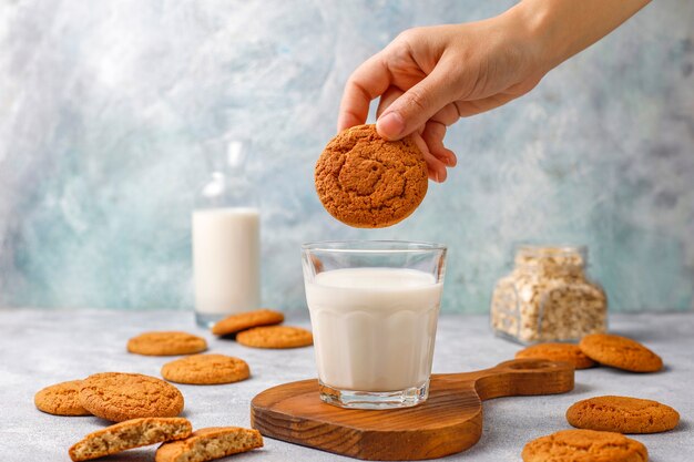 Homemade oatmeal cookies with a cup of milk.