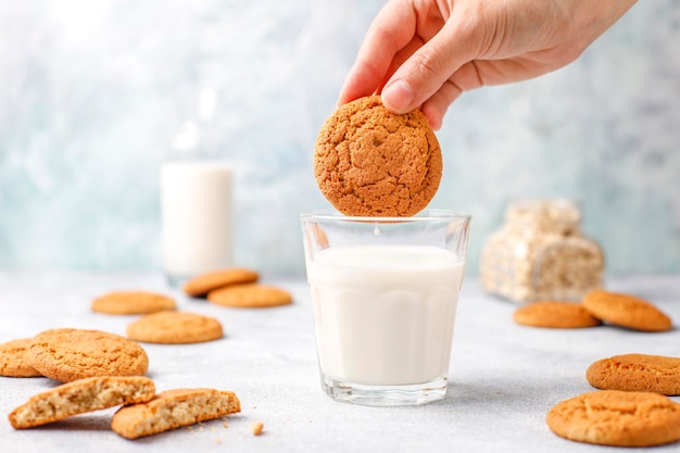 Homemade oatmeal cookies with a cup of milk.