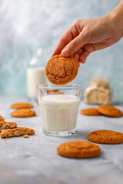 Homemade oatmeal cookies with a cup of milk.