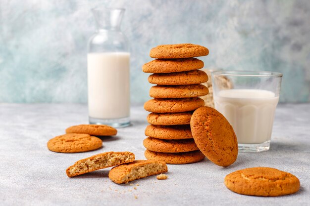 Homemade oatmeal cookies with a cup of milk.