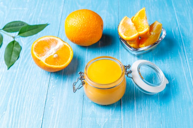 Homemade orange curd with juicy oranges.