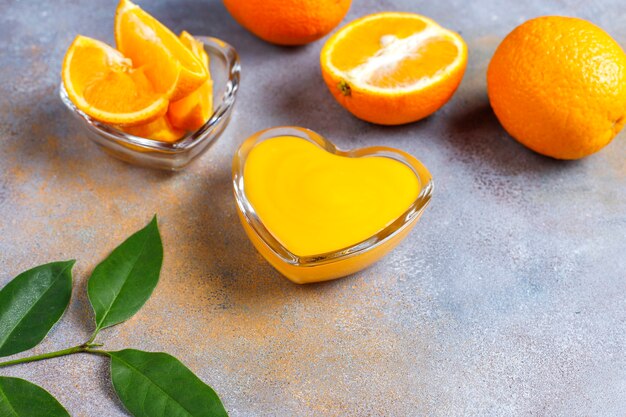 Homemade orange curd with juicy oranges.