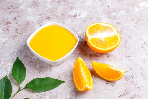 Homemade orange curd with juicy oranges.