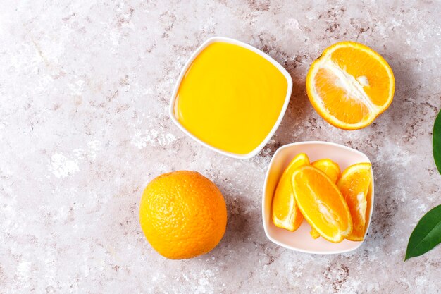 Homemade orange curd with juicy oranges.