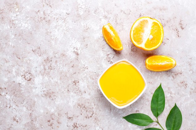 Homemade orange curd with juicy oranges.