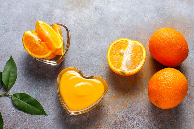 Homemade orange curd with juicy oranges.