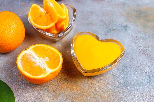 Homemade orange curd with juicy oranges.