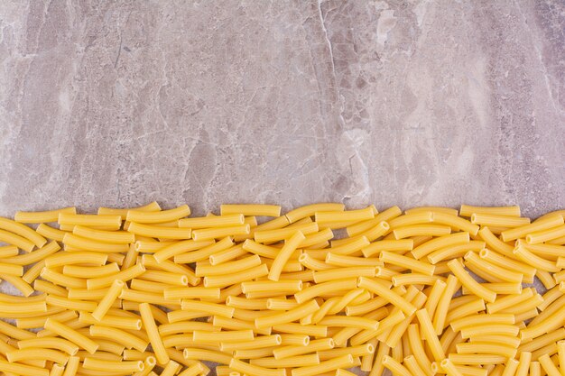 Homemade organic pastas isolated on the marble surface