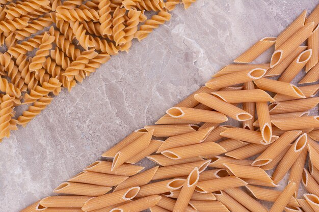 Homemade organic pastas isolated on the marble surface